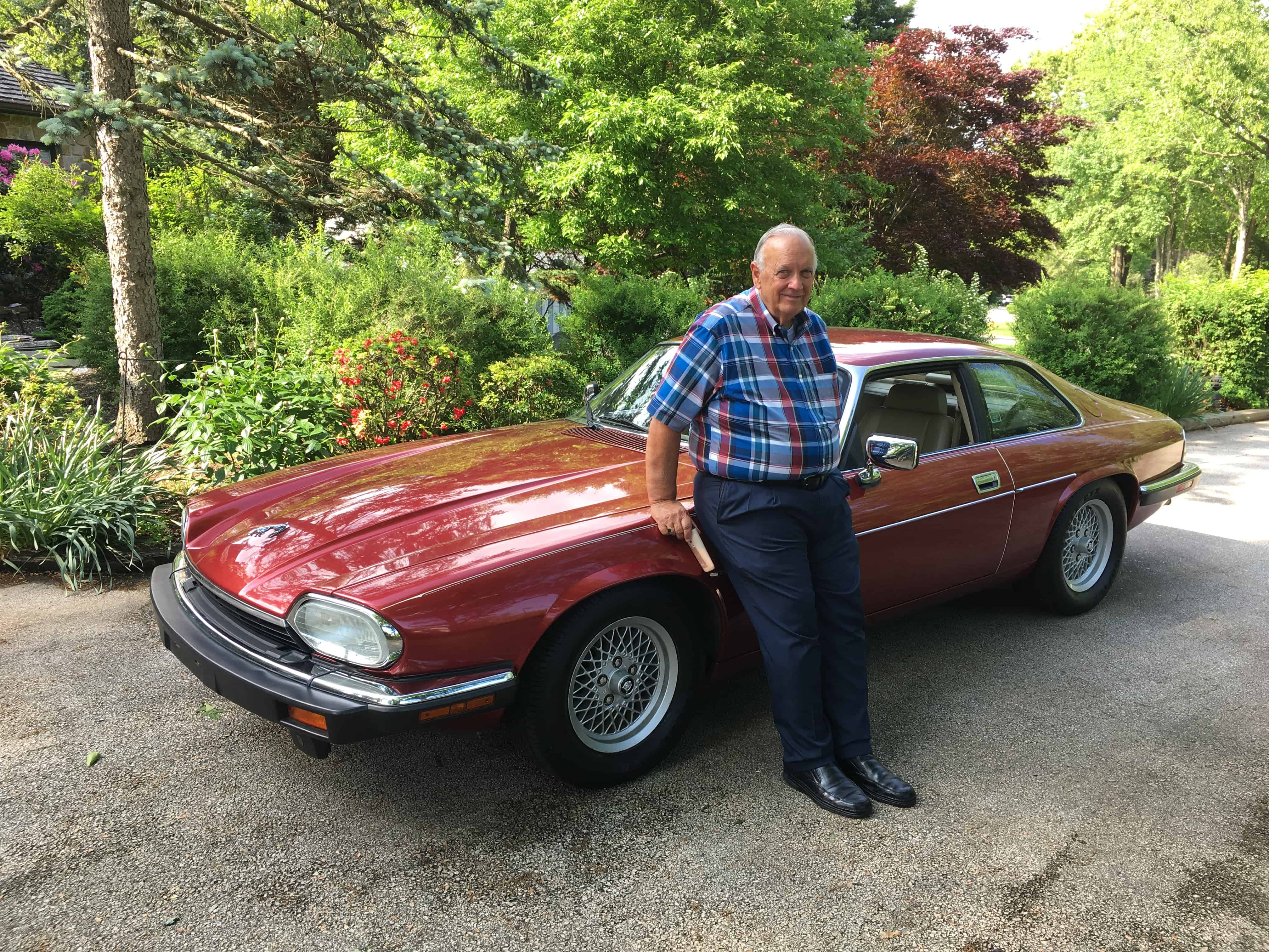 C.M.'s father poses next to a 1993 Jaguar XJS, one of a few classic cars owned by his son. | Submitted photo