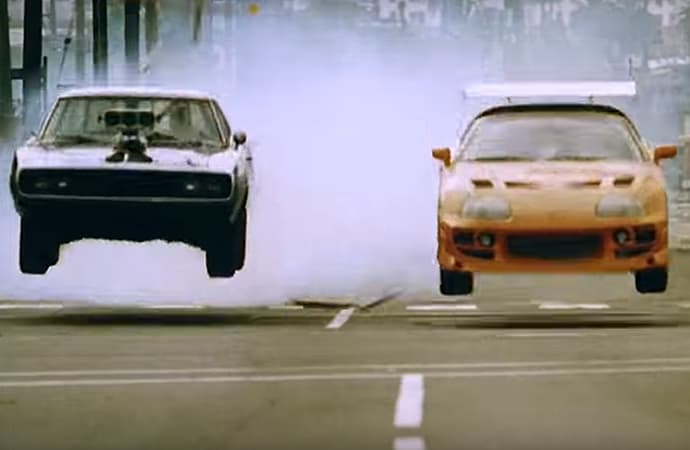 Have you ever seen a Dodge Charger and Toyota Supra not only race, but jump train tracks in the process? It happens in The Fast and the Furious. | Universal Pictures